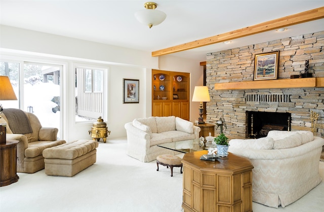 living room with carpet, beam ceiling, and a fireplace