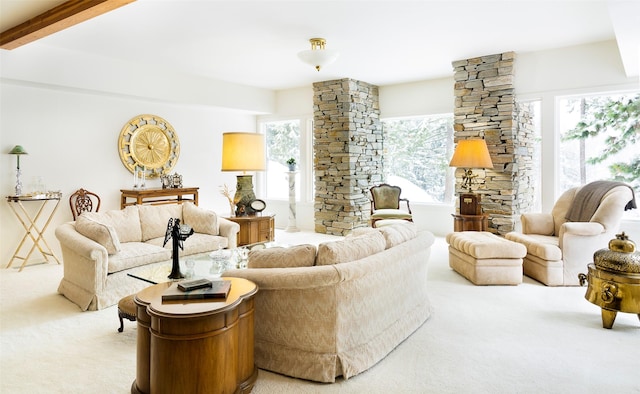 living area featuring beam ceiling and light carpet