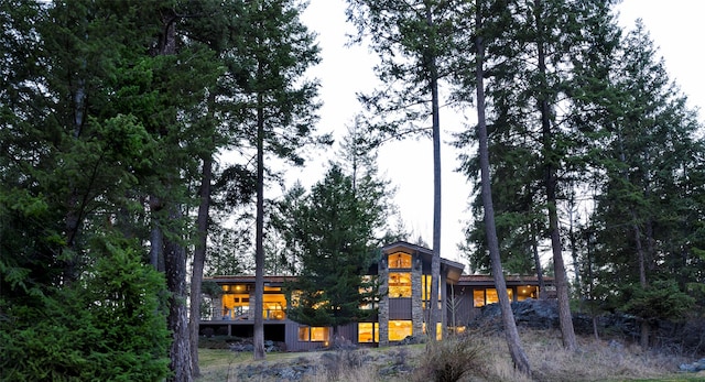 back of house with stone siding