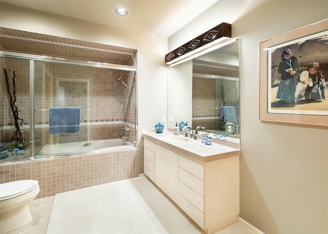 bathroom with recessed lighting, tiled shower / bath, toilet, and vanity