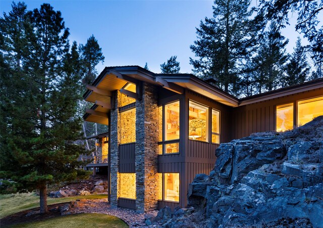 view of side of property with stone siding and board and batten siding