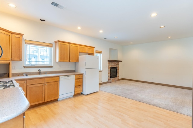 119 Oak St, Whitefish, MT 59937 - kitchen with white appliances, recessed lighting, light countertops, a stone fireplace, and light wood-style flooring