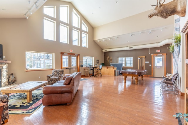 119 Oak St, Whitefish, MT 59937 - living room with rail lighting, pool table, wood-type flooring, and a fireplace
