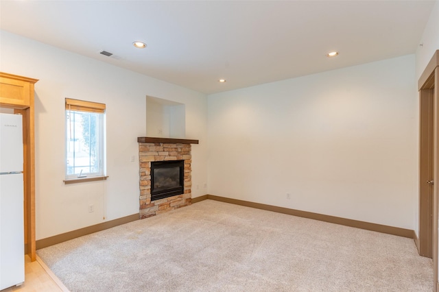 119 Oak St, Whitefish, MT 59937 - unfurnished living room featuring a stone fireplace, light carpet, and recessed lighting