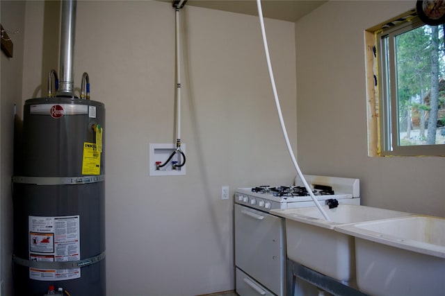 washroom featuring strapped water heater, laundry area, and hookup for a washing machine