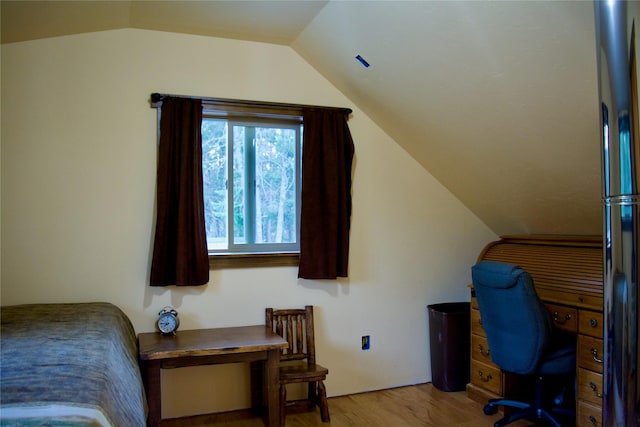 interior space featuring lofted ceiling and light wood finished floors