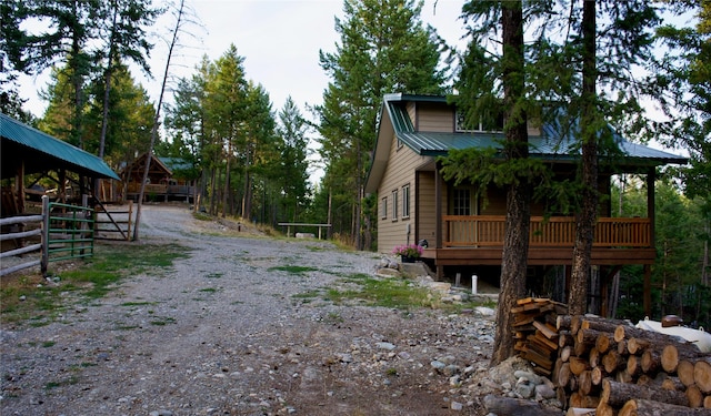 view of home's exterior with driveway and metal roof