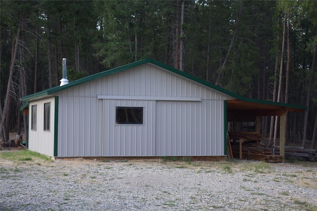 view of outbuilding featuring a view of trees