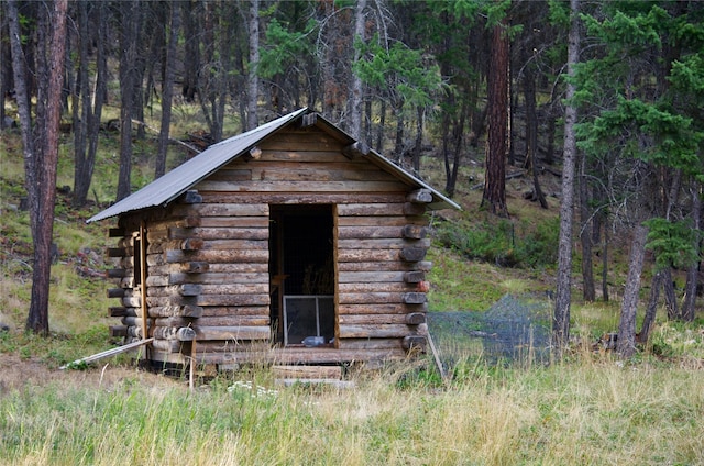 view of shed with a view of trees