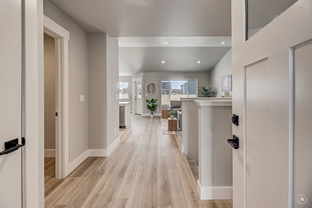 corridor with recessed lighting, baseboards, and light wood-style floors