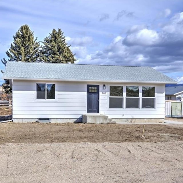 ranch-style home with roof with shingles