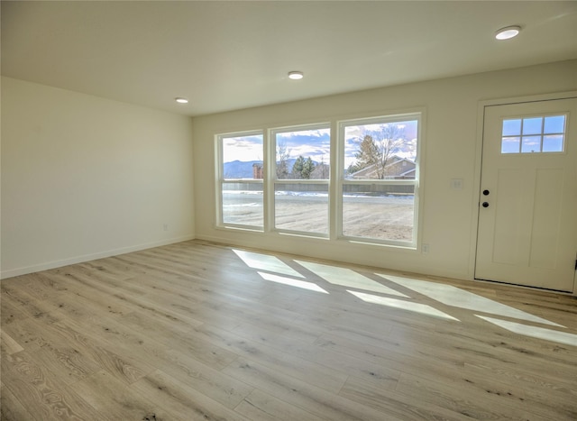 entrance foyer with light wood-style flooring, recessed lighting, and baseboards