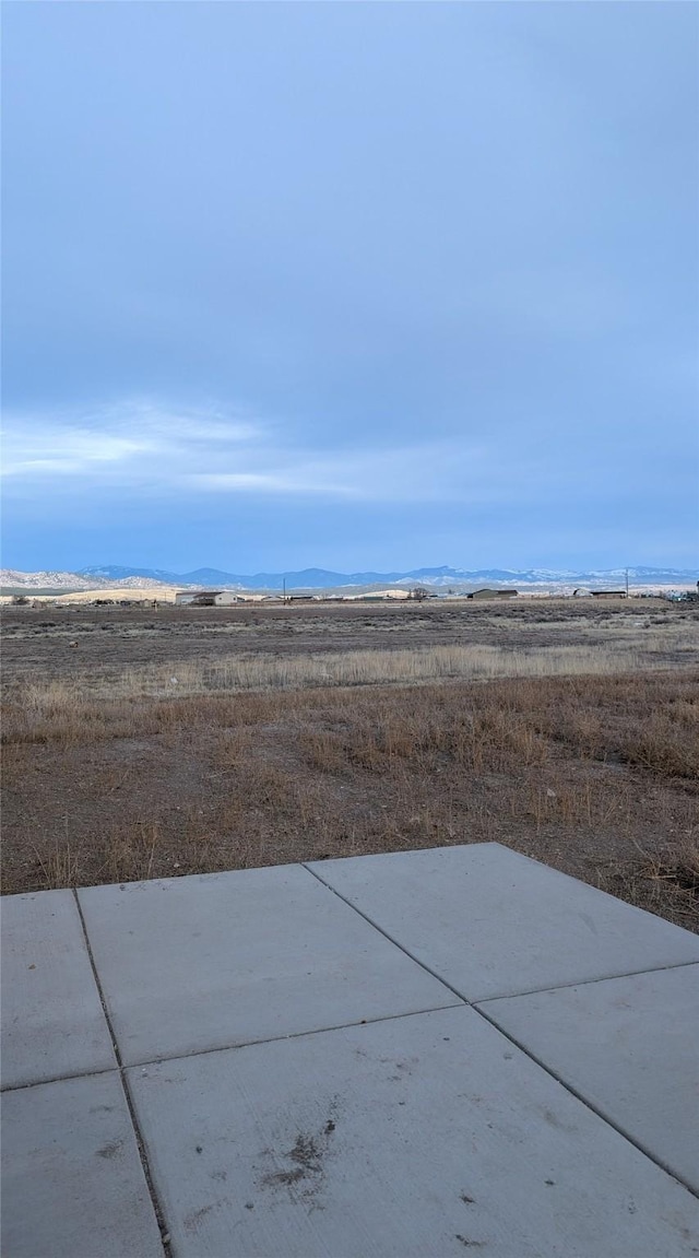 view of yard featuring a mountain view and a patio