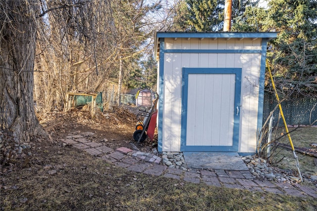 view of shed with fence