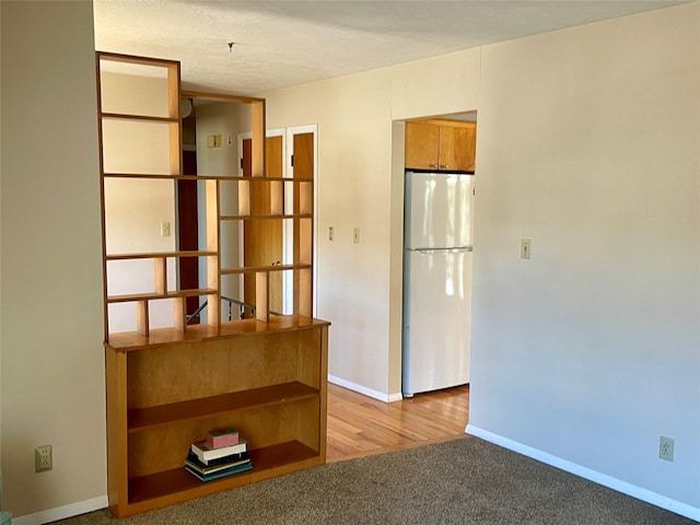 empty room featuring carpet flooring and baseboards