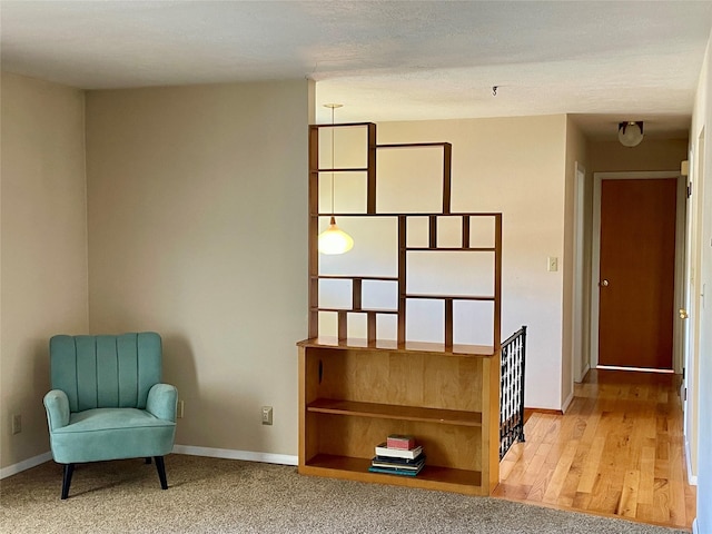 living area featuring baseboards and wood finished floors