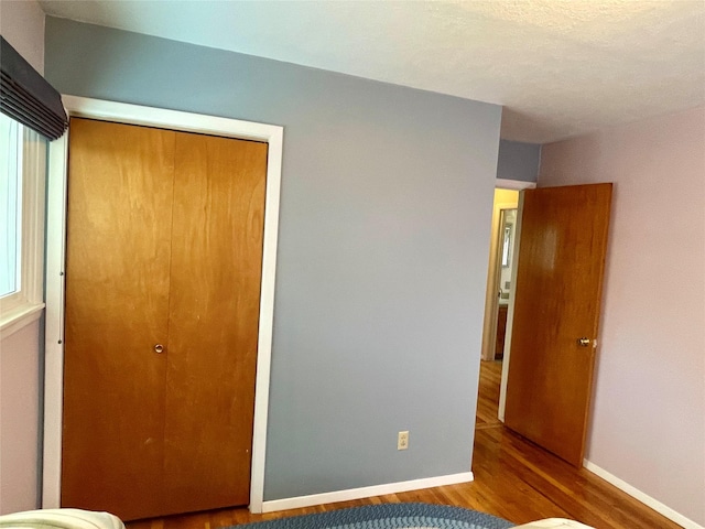 1408 Nevada Ave, Libby, MT 59923 - unfurnished bedroom featuring wood finished floors and a closet