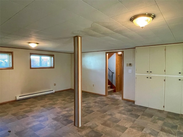 basement with tile patterned floors, stairway, baseboards, and a baseboard radiator