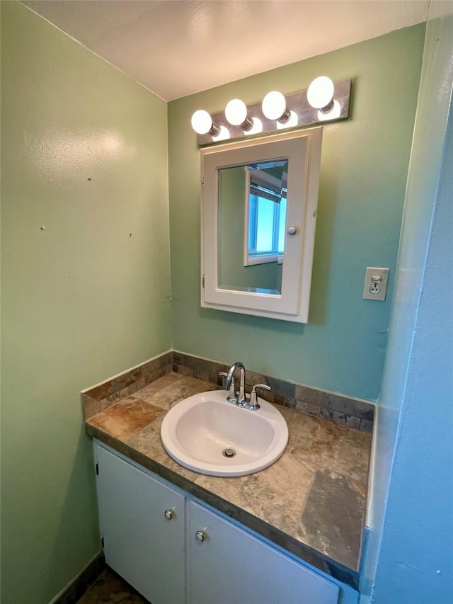 bathroom with vanity and baseboards