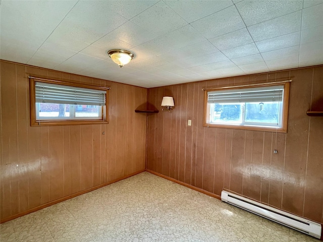 1408 Nevada Ave, Libby, MT 59923 - below grade area with baseboard heating, plenty of natural light, tile patterned floors, and wooden walls