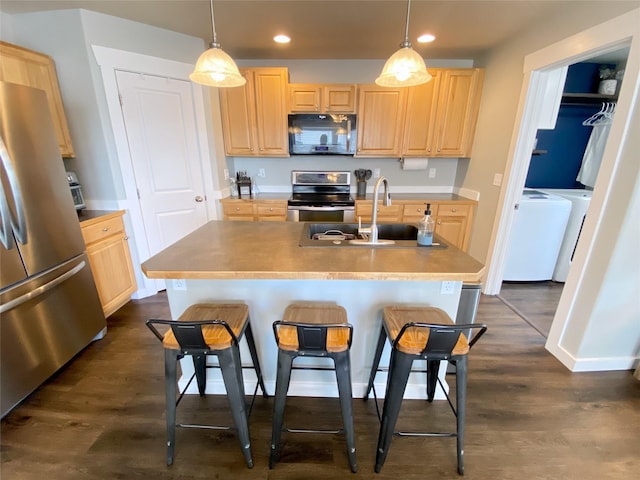 kitchen featuring recessed lighting, appliances with stainless steel finishes, dark wood finished floors, and light brown cabinetry