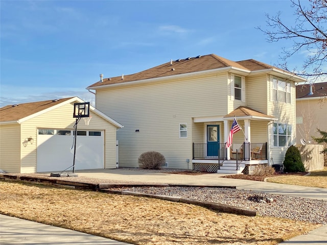 traditional-style home featuring covered porch, concrete driveway, and a garage