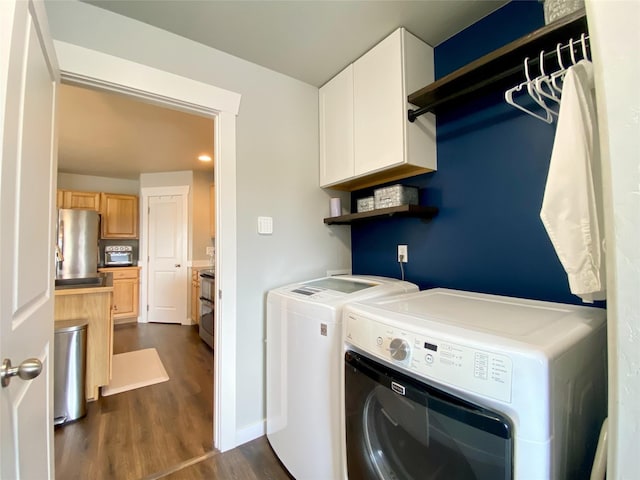 washroom with cabinet space, dark wood-style floors, independent washer and dryer, and baseboards