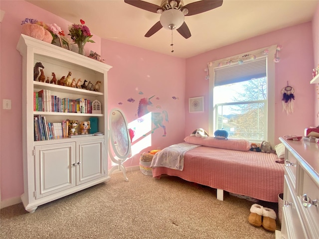 bedroom with light carpet, baseboards, and a ceiling fan