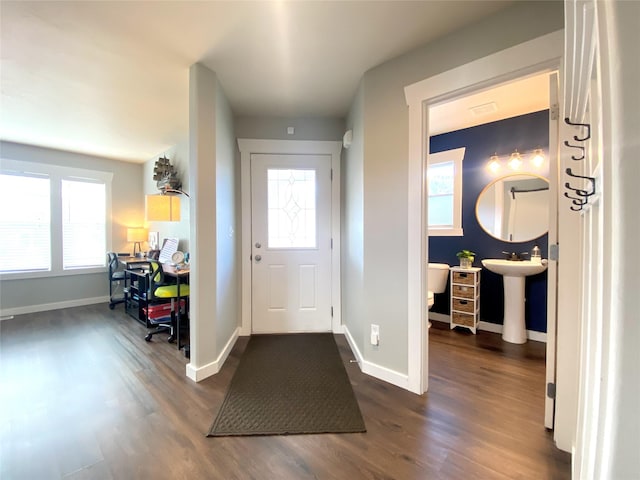 entrance foyer with baseboards and dark wood-style floors