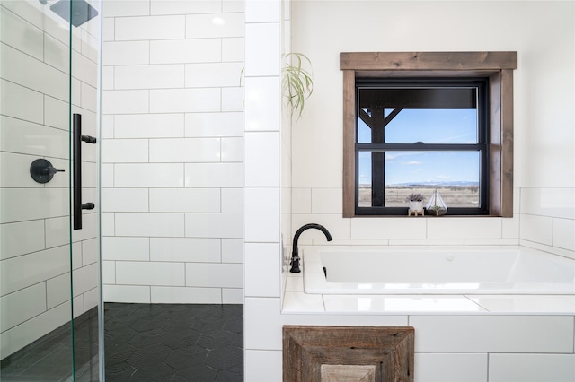 full bathroom featuring a tile shower and a garden tub