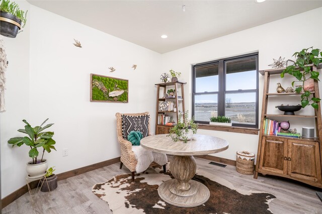 dining room with visible vents, baseboards, and wood finished floors