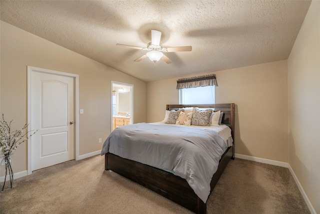 bedroom featuring baseboards, light colored carpet, connected bathroom, and lofted ceiling