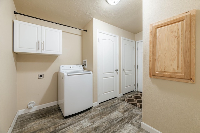 washroom with cabinet space, a textured ceiling, washer / clothes dryer, and dark wood-type flooring