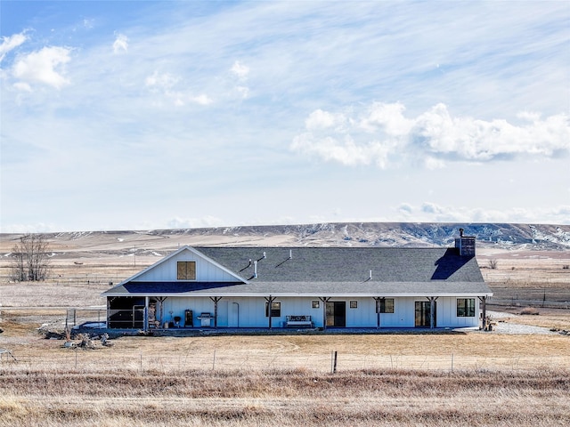 view of front of property with roof with shingles and fence