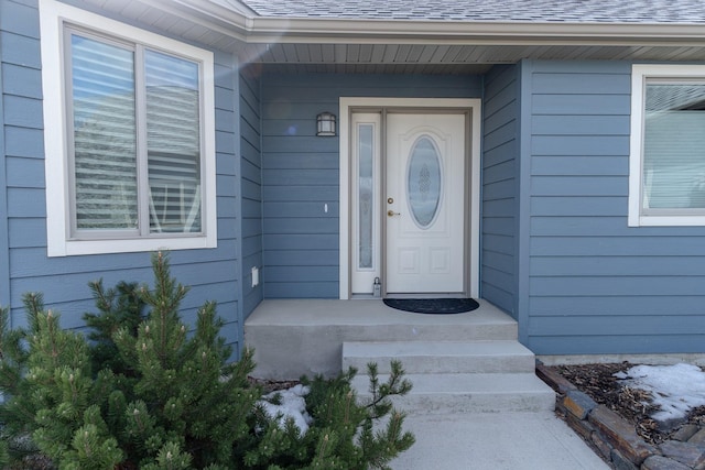 entrance to property with a shingled roof