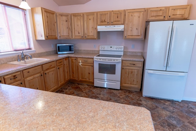 kitchen featuring light brown cabinets, under cabinet range hood, a sink, white appliances, and light countertops