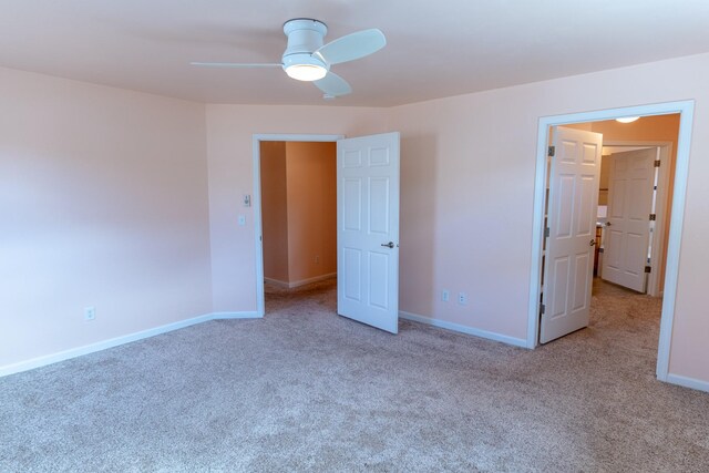 unfurnished bedroom featuring baseboards, carpet, and ceiling fan