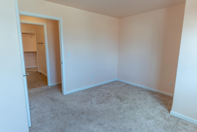 empty room with carpet flooring and baseboards