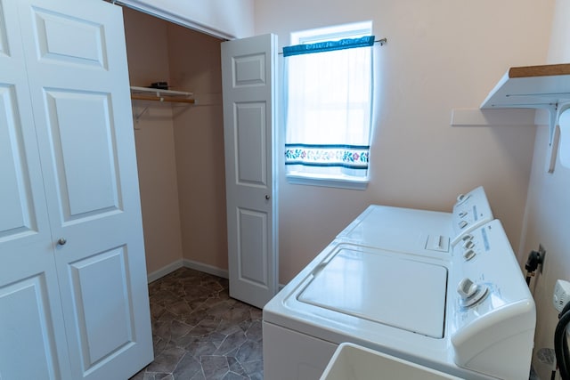 laundry area featuring laundry area, baseboards, and washer and clothes dryer