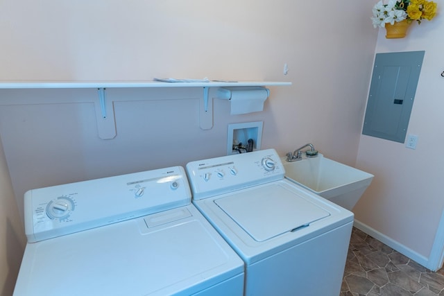 clothes washing area with independent washer and dryer, electric panel, a sink, baseboards, and laundry area