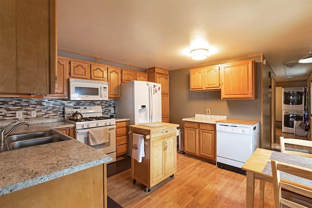 kitchen featuring white appliances, a sink, light wood-style floors, wood counters, and backsplash