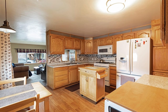 kitchen with butcher block countertops, a kitchen island, white appliances, light wood-style floors, and decorative backsplash