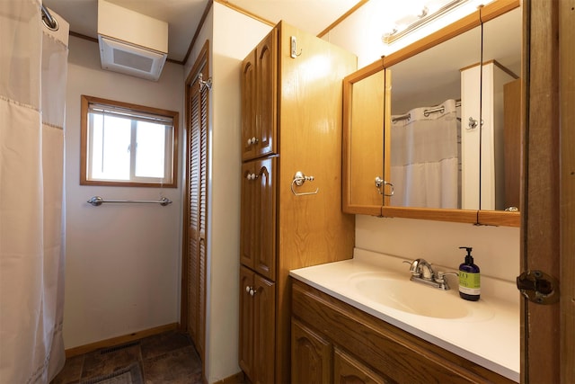 bathroom featuring baseboards and vanity