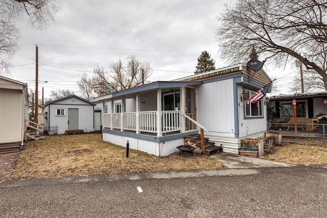 manufactured / mobile home featuring entry steps, an outbuilding, and covered porch