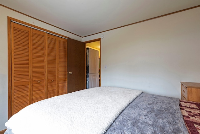 bedroom featuring a closet and ornamental molding