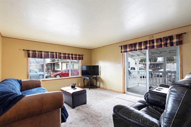 carpeted living area featuring baseboards