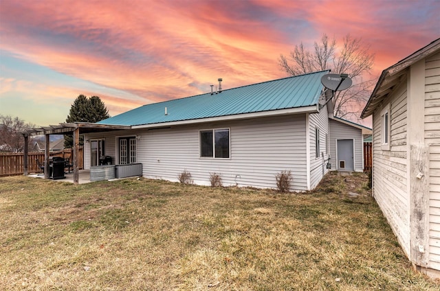 back of property with a patio, fence, a yard, a pergola, and metal roof