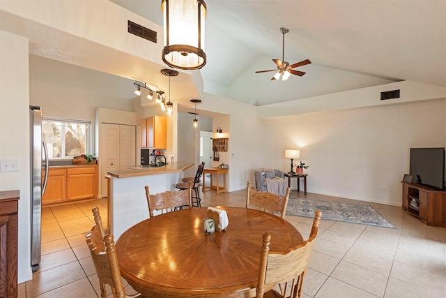 dining space featuring light tile patterned floors, visible vents, high vaulted ceiling, and a ceiling fan