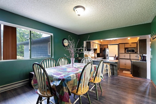 dining room featuring a textured ceiling, dark wood-type flooring, and a baseboard radiator