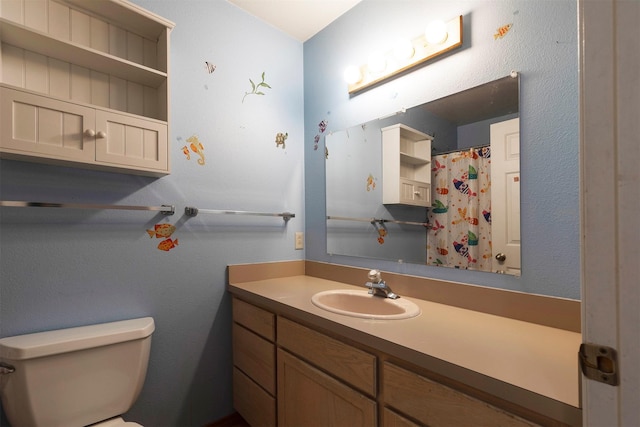 bathroom featuring toilet and vanity